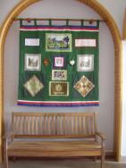 Darley Dale\'s gifts to Onzain for the 20th anniversary - a comemorative bench and a patchwork quilt with Derbyshire scenes made by ladies of Darley Dale.